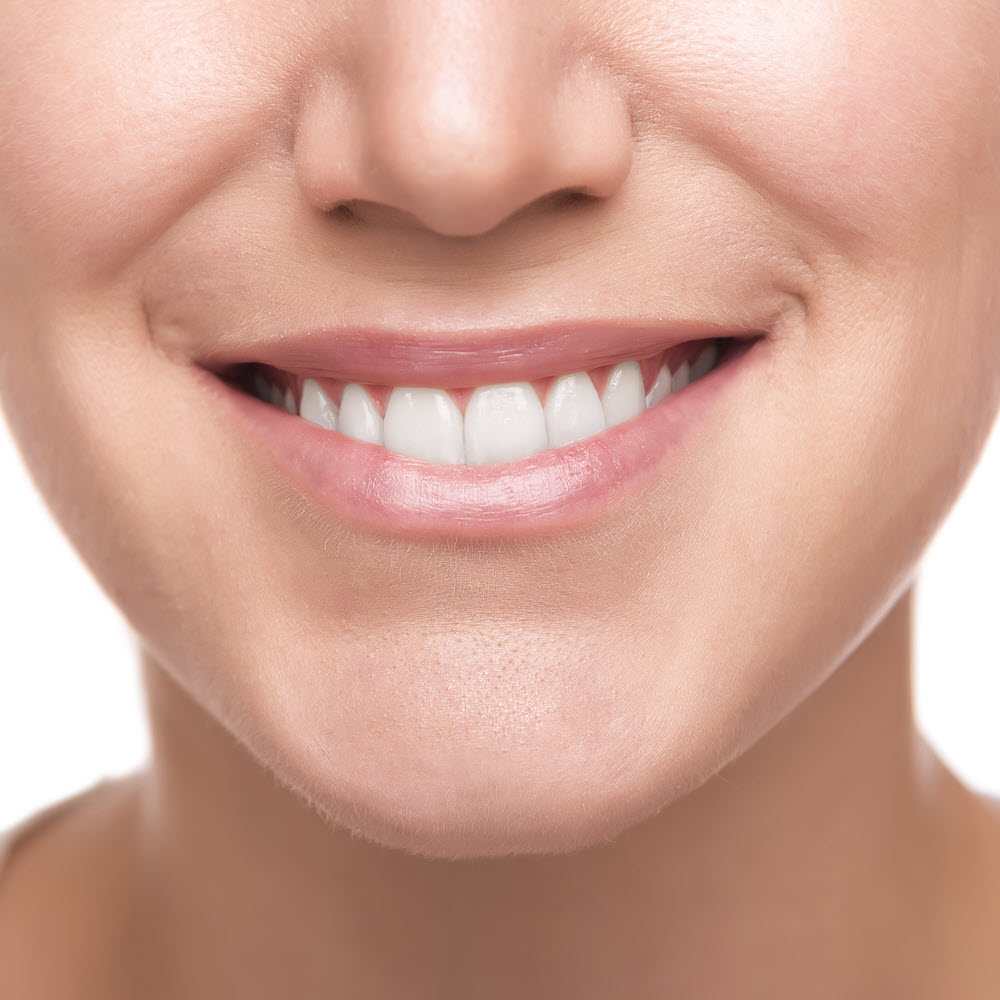 Beautiful wide smile of young woman. Closeup photo.